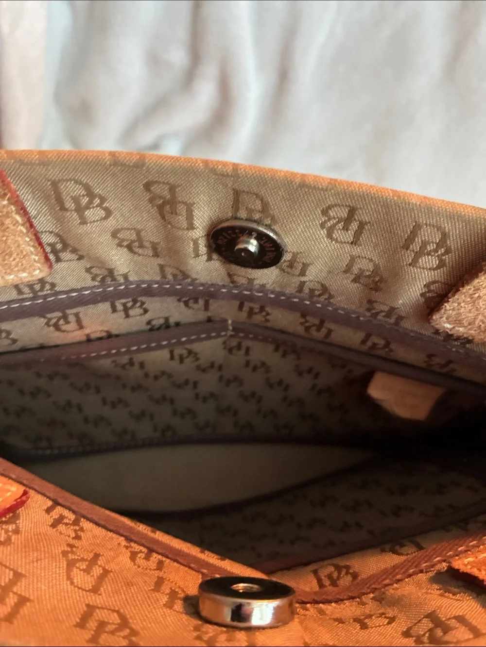 Dooney & Bourke  Brown Monogram Handbag with Tassel Accent
